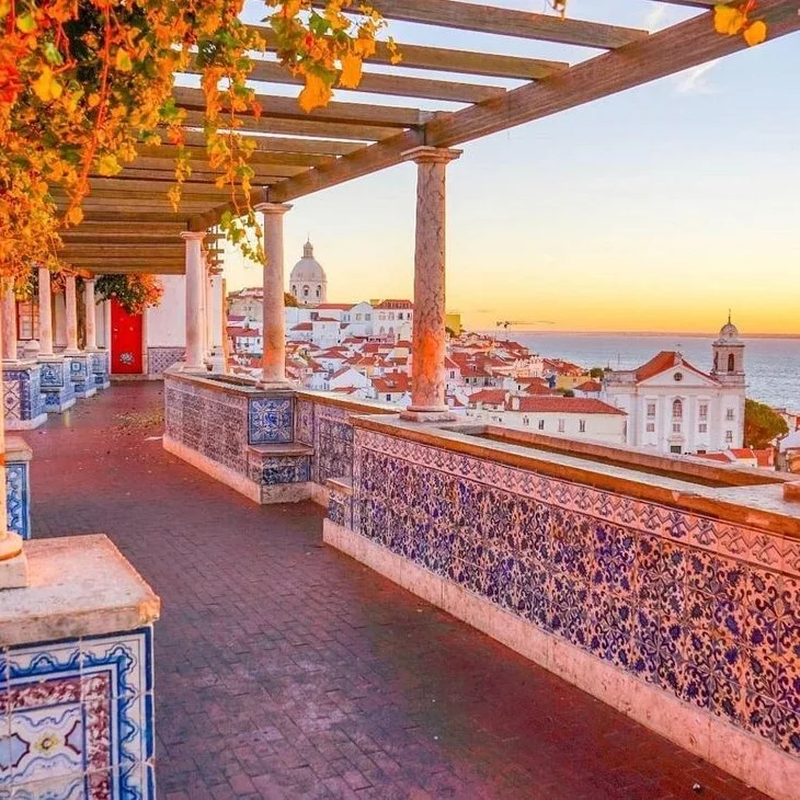 Tiled balcony overlooking Lisbon at sunset